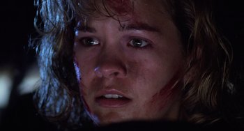 Movie still from “Halloween 4: The Return of Michael Myers” (1988), directed by Dwight H. Little – A person with blood on their face; Close Up shot, Low angle