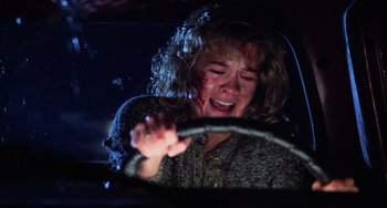 Movie still from “Halloween 4: The Return of Michael Myers” (1988), directed by Dwight H. Little – A woman in a car with blood all over her face; Close Up shot, High angle