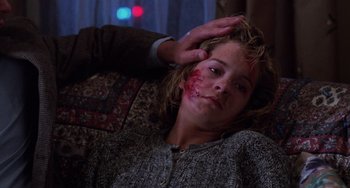 Movie still from “Halloween 4: The Return of Michael Myers” (1988), directed by Dwight H. Little – A woman with a cut on her face and a man touching her hair; Close Up shot, High angle