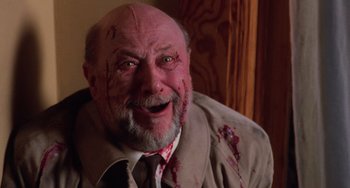Movie still from “Halloween 4: The Return of Michael Myers” (1988), directed by Dwight H. Little – An old man with a beard and a bloody face; Close Up shot, High angle