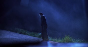 Movie still from “Halloween 5: The Revenge of Michael Myers” (1989), directed by Dominique Othenin-Girard – A person standing on a street at night; Wide shot, Low angle