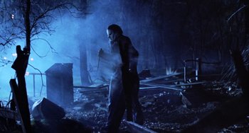 Movie still from “Halloween 5: The Revenge of Michael Myers” (1989), directed by Dominique Othenin-Girard – Two people walking through a forest at night; Wide shot, Low angle