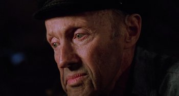 Movie still from “Halloween 5: The Revenge of Michael Myers” (1989), directed by Dominique Othenin-Girard – An older man wearing a black hat looking at the camera; Close Up shot, High angle