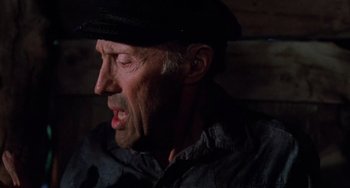 Movie still from “Halloween 5: The Revenge of Michael Myers” (1989), directed by Dominique Othenin-Girard – An older man wearing a black hat and a black shirt; Close Up shot, High angle