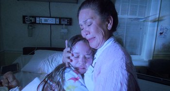 Movie still from “Halloween 5: The Revenge of Michael Myers” (1989), directed by Dominique Othenin-Girard – An older woman holding a young girl in her arms; Medium shot, Low angle