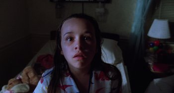 Movie still from “Halloween 5: The Revenge of Michael Myers” (1989), directed by Dominique Othenin-Girard – A young girl sitting on a bed in a room; Close Up shot, Low angle