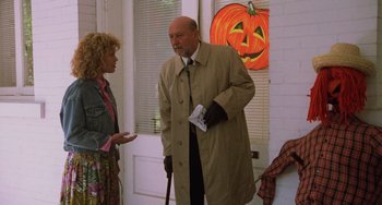 Movie still from “Halloween 5: The Revenge of Michael Myers” (1989), directed by Dominique Othenin-Girard – A man in a trench coat talking to a woman; Medium shot, Low angle