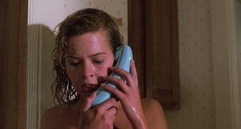 Movie still from “Halloween 5: The Revenge of Michael Myers” (1989), directed by Dominique Othenin-Girard – A woman holding a phone up to her face; Close Up shot, Low angle