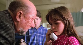 Movie still from “Halloween 5: The Revenge of Michael Myers” (1989), directed by Dominique Othenin-Girard – An older man and a young girl on a phone; Close Up shot, Over the shoulder angle