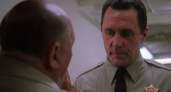 Movie still from “Halloween 5: The Revenge of Michael Myers” (1989), directed by Dominique Othenin-Girard – A man wearing a police uniform talking to another man in a uniform; Close Up shot, Low angle
