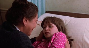 Movie still from “Halloween 5: The Revenge of Michael Myers” (1989), directed by Dominique Othenin-Girard – A young girl in a pink polka dot shirt is comforted by a woman; Close Up shot, Over the shoulder angle