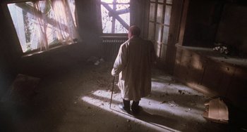 Movie still from “Halloween 5: The Revenge of Michael Myers” (1989), directed by Dominique Othenin-Girard – An old man with a walking stick looking out of a window; Wide shot, High angle