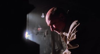 Movie still from “Halloween 5: The Revenge of Michael Myers” (1989), directed by Dominique Othenin-Girard – An older bald man with a goatee looking down; Close Up shot, Low angle