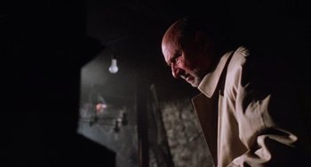 Movie still from “Halloween 5: The Revenge of Michael Myers” (1989), directed by Dominique Othenin-Girard – A bald man with a goatee is looking down; Close Up shot, Low angle