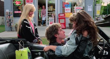 Movie still from “Halloween 5: The Revenge of Michael Myers” (1989), directed by Dominique Othenin-Girard – A group of young people sitting on top of a motorcycle; Medium shot, Over the shoulder angle