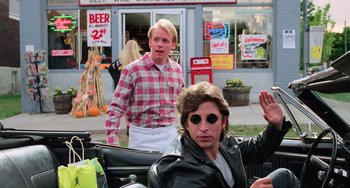 Movie still from “Halloween 5: The Revenge of Michael Myers” (1989), directed by Dominique Othenin-Girard – Two men in plaid shirts are standing in front of a store; Medium shot, Over the shoulder angle