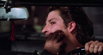 Movie still from “Halloween 5: The Revenge of Michael Myers” (1989), directed by Dominique Othenin-Girard – A person in a car with his hand to his face; Close Up shot, Over the shoulder angle