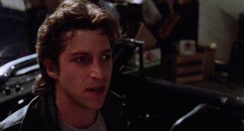 Movie still from “Halloween 5: The Revenge of Michael Myers” (1989), directed by Dominique Othenin-Girard – A young man with short brown hair wearing a leather jacket; Close Up shot, Low angle