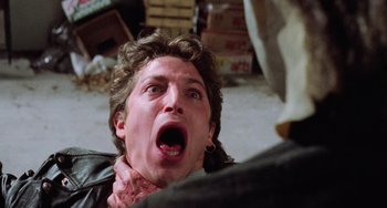 Movie still from “Halloween 5: The Revenge of Michael Myers” (1989), directed by Dominique Othenin-Girard – A man with his mouth wide open and his head in his hands; Close Up shot, Over the shoulder angle