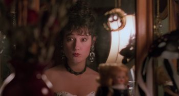 Movie still from “Halloween 5: The Revenge of Michael Myers” (1989), directed by Dominique Othenin-Girard – A young woman looking into a mirror while wearing a necklace and earrings; Close Up shot, High angle
