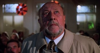 Movie still from “Halloween 5: The Revenge of Michael Myers” (1989), directed by Dominique Othenin-Girard – An older man with a beard wearing a jacket and tie; Close Up shot, Low angle