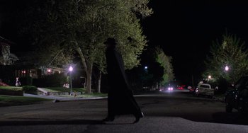 Movie still from “Halloween 5: The Revenge of Michael Myers” (1989), directed by Dominique Othenin-Girard – A man walking down a street at night; Wide shot, Low angle