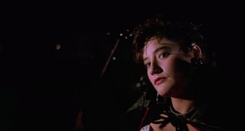 Movie still from “Halloween 5: The Revenge of Michael Myers” (1989), directed by Dominique Othenin-Girard – A young woman wearing a collar and a necklace; Close Up shot, Low angle