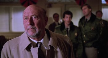 Movie still from “Halloween 5: The Revenge of Michael Myers” (1989), directed by Dominique Othenin-Girard – An older man wearing a tie and a jacket; Close Up shot, Low angle