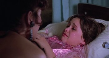Movie still from “Halloween 5: The Revenge of Michael Myers” (1989), directed by Dominique Othenin-Girard – A young girl laying in a bed with her mother; Close Up shot, Over the shoulder angle