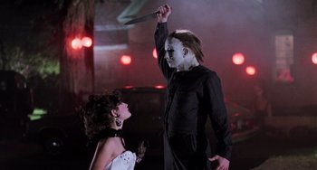 Movie still from “Halloween 5: The Revenge of Michael Myers” (1989), directed by Dominique Othenin-Girard – A man and a woman dressed up in costume; Medium shot, Low angle