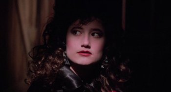 Movie still from “Halloween 5: The Revenge of Michael Myers” (1989), directed by Dominique Othenin-Girard – A person with long curly hair; Close Up shot, Over the shoulder angle