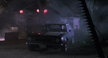 Movie still from “Halloween 5: The Revenge of Michael Myers” (1989), directed by Dominique Othenin-Girard – An old car parked in the dark under a bridge; Wide shot, Low angle