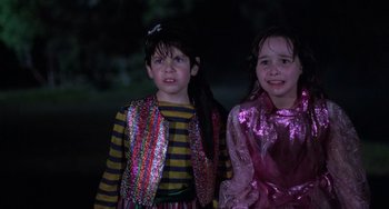 Movie still from “Halloween 5: The Revenge of Michael Myers” (1989), directed by Dominique Othenin-Girard – Two young children dressed up for halloween posing for the camera; Medium shot, Over the shoulder angle