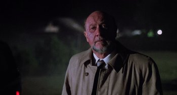 Movie still from “Halloween 5: The Revenge of Michael Myers” (1989), directed by Dominique Othenin-Girard – An older man wearing a brown coat and a white tie; Close Up shot, Low angle