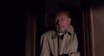 Movie still from “Halloween 5: The Revenge of Michael Myers” (1989), directed by Dominique Othenin-Girard – An older man wearing a tan jacket and a white shirt; Close Up shot, Low angle