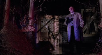 Movie still from “Halloween 5: The Revenge of Michael Myers” (1989), directed by Dominique Othenin-Girard – A man standing in front of a door at night; Wide shot, Low angle