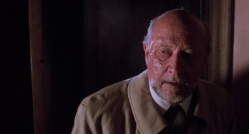 Movie still from “Halloween 5: The Revenge of Michael Myers” (1989), directed by Dominique Othenin-Girard – An older man wearing a suit and tie; Close Up shot, High angle