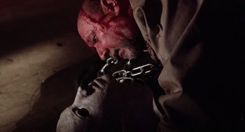 Movie still from “Halloween 5: The Revenge of Michael Myers” (1989), directed by Dominique Othenin-Girard – A man with a chain around his neck and face; Close Up shot, Low angle