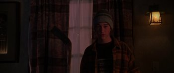 Movie still from “Halloween H20: 20 Years Later” (1998), directed by Steve Miner – A young man standing in front of a window; Medium shot, High angle