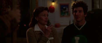 Movie still from “Halloween H20: 20 Years Later” (1998), directed by Steve Miner – A woman is talking to a man at a party; Medium shot, Over the shoulder angle