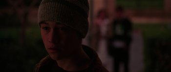 Movie still from “Halloween H20: 20 Years Later” (1998), directed by Steve Miner – A young man wearing a hat in a dark room; Close Up shot, Over the shoulder angle