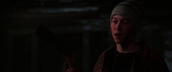 Movie still from “Halloween H20: 20 Years Later” (1998), directed by Steve Miner – A man in a hat is holding something in his hand; Close Up shot, Over the shoulder angle