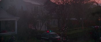 Movie still from “Halloween H20: 20 Years Later” (1998), directed by Steve Miner – A police car parked in front of a christmas tree; Extreme Wide shot, High angle