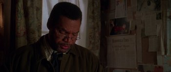 Movie still from “Halloween H20: 20 Years Later” (1998), directed by Steve Miner – A man in glasses and a jacket looking down; Close Up shot, Over the shoulder angle