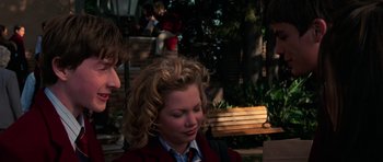 Movie still from “Halloween H20: 20 Years Later” (1998), directed by Steve Miner – A woman with curly blonde hair wearing a red jacket; Medium shot, Over the shoulder angle