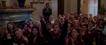 Movie still from “Halloween H20: 20 Years Later” (1998), directed by Steve Miner – A group of young people sitting in a room with their hands raised; Medium shot, Low angle