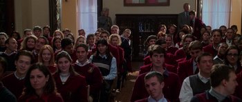 Movie still from “Halloween H20: 20 Years Later” (1998), directed by Steve Miner – A large group of people in red jackets sitting in a room; Medium shot, High angle