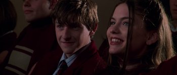 Movie still from “Halloween H20: 20 Years Later” (1998), directed by Steve Miner – A man and a woman smiling for the camera; Close Up shot, Over the shoulder angle