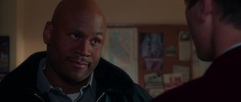 Movie still from “Halloween H20: 20 Years Later” (1998), directed by Steve Miner – A man's face in front of a painting; Close Up shot, Over the shoulder angle