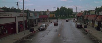 Movie still from “Halloween H20: 20 Years Later” (1998), directed by Steve Miner – Cars driving down a street in the rain; Extreme Wide shot, High angle
